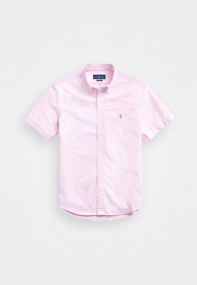 Short-sleeve, button-up shirt in light pink cotton with a classic collar and small embroidered logo on the chest. Features rounded hem.