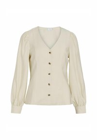 Blusa color crema con scollo a V, maniche lunghe a sbuffo e chiusura frontale con bottoni marroni per un tocco di dettaglio.
