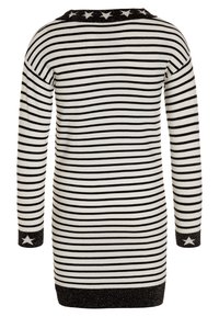 Pruhované svetrové šaty v černé a bílé barvě, s dlouhými rukávy a černým třpytivým vzorem hvězd na límci a manžetách.