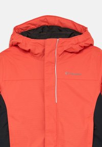 Veste en corail imperméable avec une bordure noire, dotée d'une capuche à cordon de serrage, d'une fermeture éclair sur le devant et d'un petit logo sur la poitrine. Texture lisse.