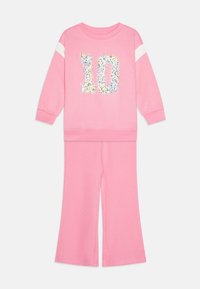 Pink sweatshirt and pants set featuring a sequined floral "10" on the top and white stripe accents on the sleeves. Soft, stretchy fabric.