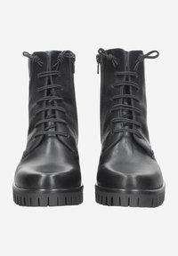 Bottines en cuir noir avec un bout rond, un laçage à l'avant et des zips sur le côté. Elles disposent de semelles en caoutchouc striées pour une meilleure adhérence.