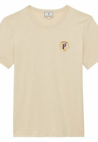 T-shirt en coton de couleur crème avec un col rond et des manches courtes, doté d'un logo coloré sur la zone du côté gauche de la poitrine.
