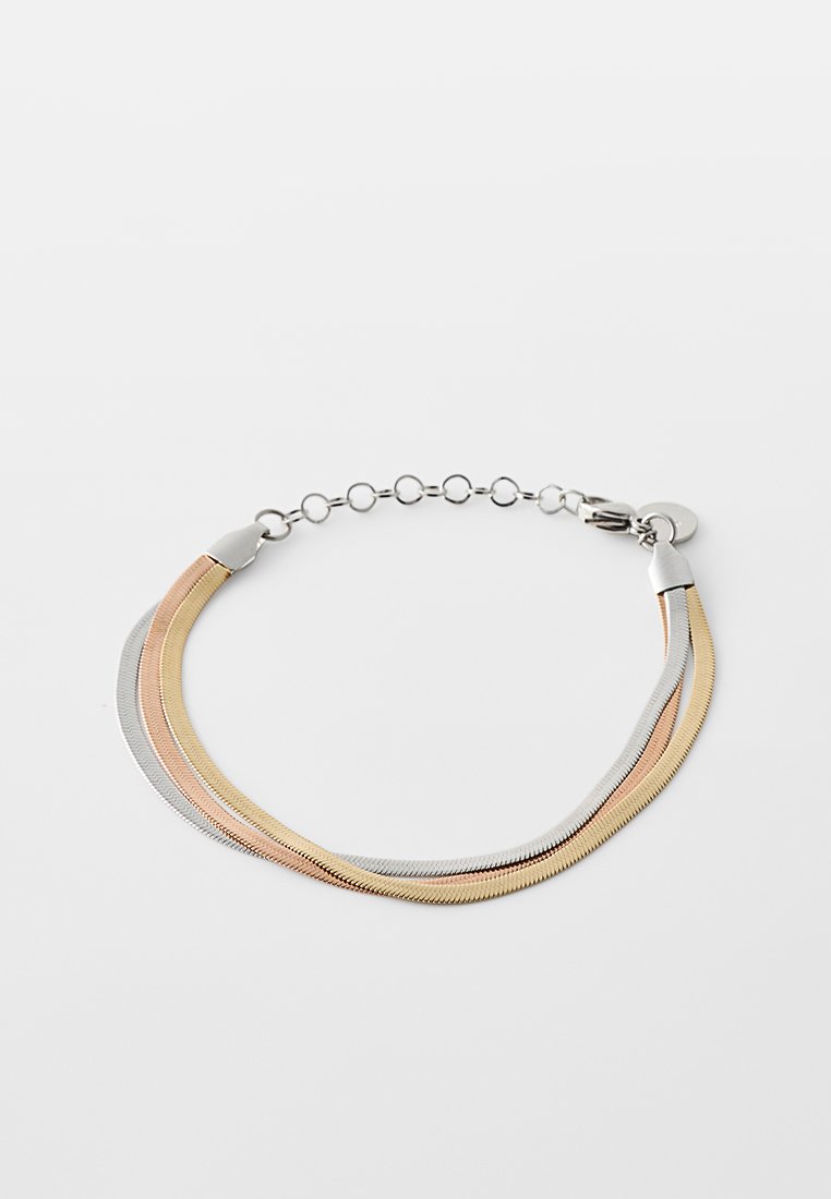 Metalowa bransoletka z trzema splotami w odcieniach złota, srebra i różowego złota. Posiada zapięcie oraz okrągły łańcuszek do regulacji. Gładka tekstura.