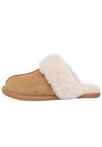 Tan suede slipper with a soft, cream fur cuff, flat sole, and simple stitching. The brand logo is embossed on the side.