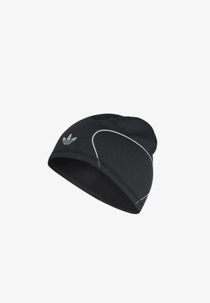 Black Adidas beanie hat with white curved reflective lines and Adidas Trefoil logo on side, made of soft, stretchy fabric.