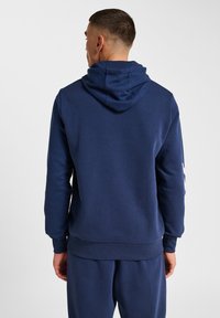 Granatowy bluza z kapturem ze sznurkiem, prążkowanymi mankietami i dołem. Gładka faktura tkaniny z minimalistycznym wzornictwem.