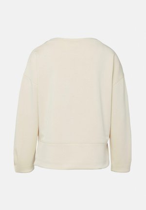 Kremowa bluza z długim rękawem i okrągłym dekoltem, z opuszczonym szwem na ramieniu, widocznym poziomym szwem blisko dolnego brzegu, pokazana od tyłu.