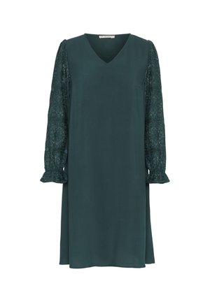 Tummansininen mekko V-päällä, jossa on pitkät pitsihihat ja röyhelökaulukset. Sileä rakenne, polvimittainen, rento istuvuus.