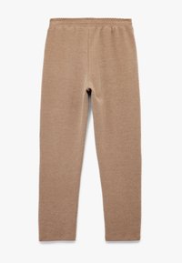 Tan leggings lavet af blødt, strækbart stof med en elastisk talje, designet med en kropsb formet silhuet og glat tekstur.