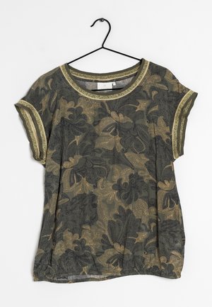 Short-sleeve dark green and gold floral patterned blouse with gold trim on neckline and sleeves hanging on a black hanger.