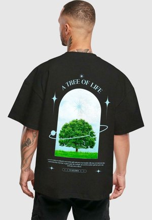 Black oversized t-shirt featuring a colorful graphic of a green tree inside an arch, with the text "A TREE OF LIFE" above and decorative accents.