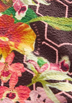 Floral patterned fabric featuring vibrant colors, including pink, green, and yellow, on a dark background with a textured surface.