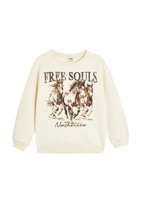 Sudadera de color crema con un corte oversized, con un gráfico de caballos galopantes y la inscripción "FREE SOULS Nashville" en texto marrón.