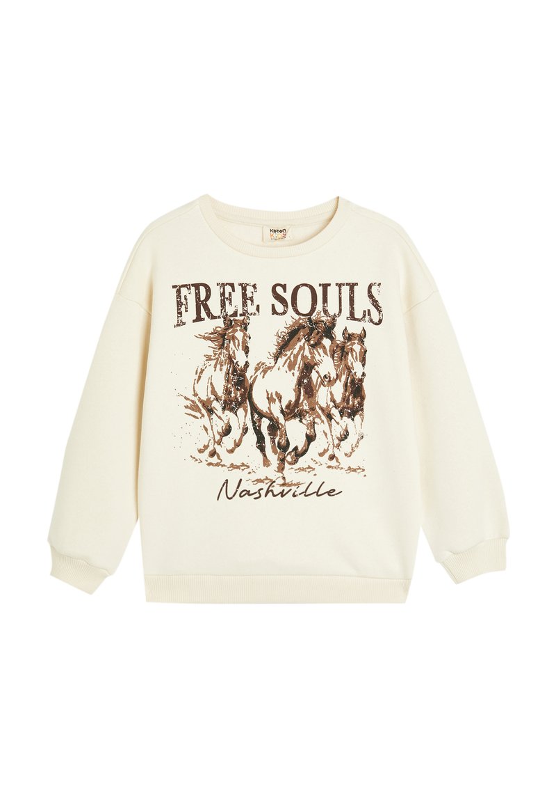 Sudadera de color crema con un corte oversized, con un gráfico de caballos galopantes y la inscripción "FREE SOULS Nashville" en texto marrón.