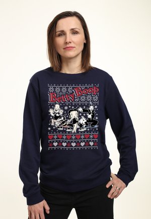 Marineblå sweatshirt med et farverigt Betty Boop grafisk design, der inkluderer tegneseriefigurer, snefnug, hjerter og et festligt motiv.