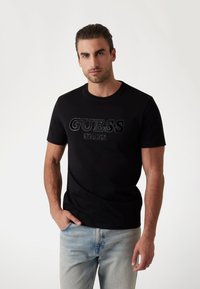 Guess LOGO BEFLOCKUNG - Camiseta estampada - schwarz