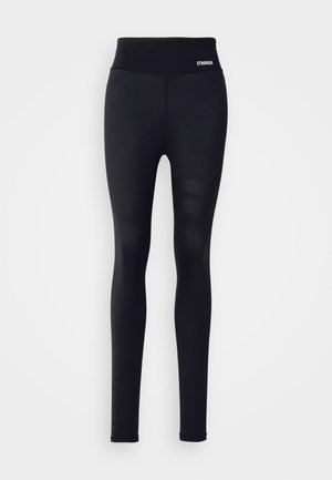 Black leggings with a high waistband, made of smooth, stretchy fabric. Features a breathable mesh pattern on the lower leg. Logo on waistband.