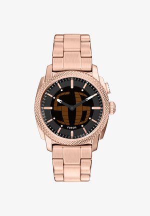 Montre bracelet en métal rose doré avec cadran noir, lunette texturée, marqueurs simples et deux aiguilles indiquant 10h10.