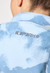 Light blue jacket featuring a nature-inspired pattern and "ICEPEAK" logo in dark gray. Smooth fabric with a structured collar.
