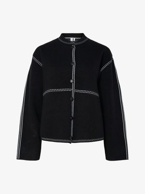 Black button-up jacket with a high collar. Features contrasting white stitching along the seams and buttons, structured shape, and long sleeves.