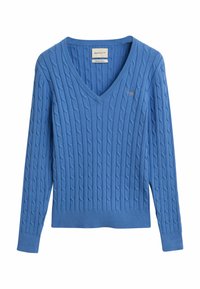 Blue knitted sweater featuring a V-neck, cable design, ribbed cuffs, and hem. Small logo accent on the chest. Made from soft cotton material.