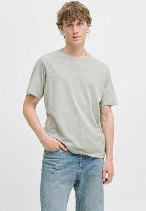 Light grey short-sleeve t-shirt made of soft cotton, featuring a crew neckline and relaxed fit, paired with blue denim jeans.