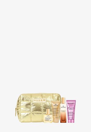 Borsa cosmetica trapuntata dorata NUXE Paris con piccoli flaconi e tubetti di prodotti di bellezza profumati Prodigieux.