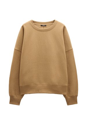 Beżowa bluza z okrągłym dekoltem, opadłymi ramionami oraz prążkowanymi mankietami i dołem. Miękka, gładka tekstura bez wzorów i akcentów.