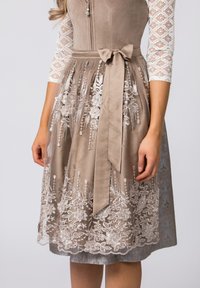 Dress with a fitted, suede-like bodice, beige fabric, and lace trim featuring floral patterns; includes a coordinating belt and layered skirt.