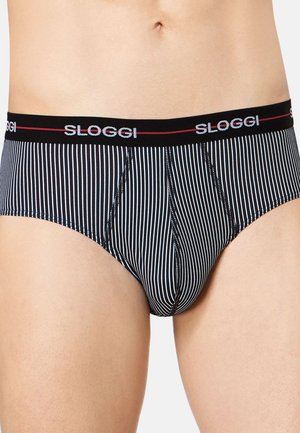 Male waist wearing black and white vertically striped briefs with a black waistband featuring "SLOGGI" in white letters.