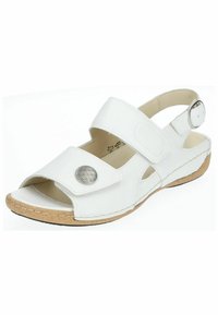 Sandale en cuir blanc avec des brides réglables, accent argenté rond, design à bout ouvert et semelle de style liège. Présente des détails de couture le long du bord.