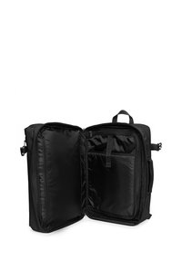 Black fabric backpack with an open double-zipper, featuring a spacious main compartment, smooth interior lining, and an interior pocket.