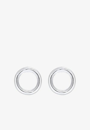 Pendientes circulares de plata con un acabado pulido. Presentan un diseño simple y suave, con un centro hueco que realza la reflexión de la luz.