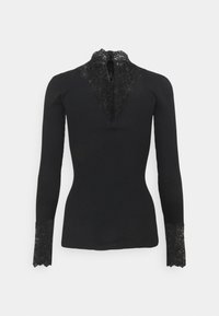 Svart långärmad topp med ribbat mönster, prydd med spetsdetaljer vid kragen och spetskant vid ärmsluten. Bakre dragkedjestängning.
