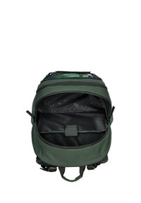 Green fabric backpack with a zippered top, featuring a patterned interior and a flat pocket, designed for storage and organization.