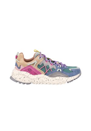 Chunky multicolor sneaker with beige, pink, teal, blue, and purple suede panels, purple laces, and speckled white sole with tread.