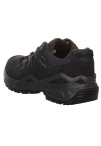 Black hiking shoe featuring a suede and textile upper, textured rubber sole, raised heel, and a reinforced heel cap for added support.