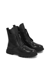 Black leather ankle boots with a chunky rubber sole, featuring side zippers and a smooth finish. High top with minimal hardware accents.