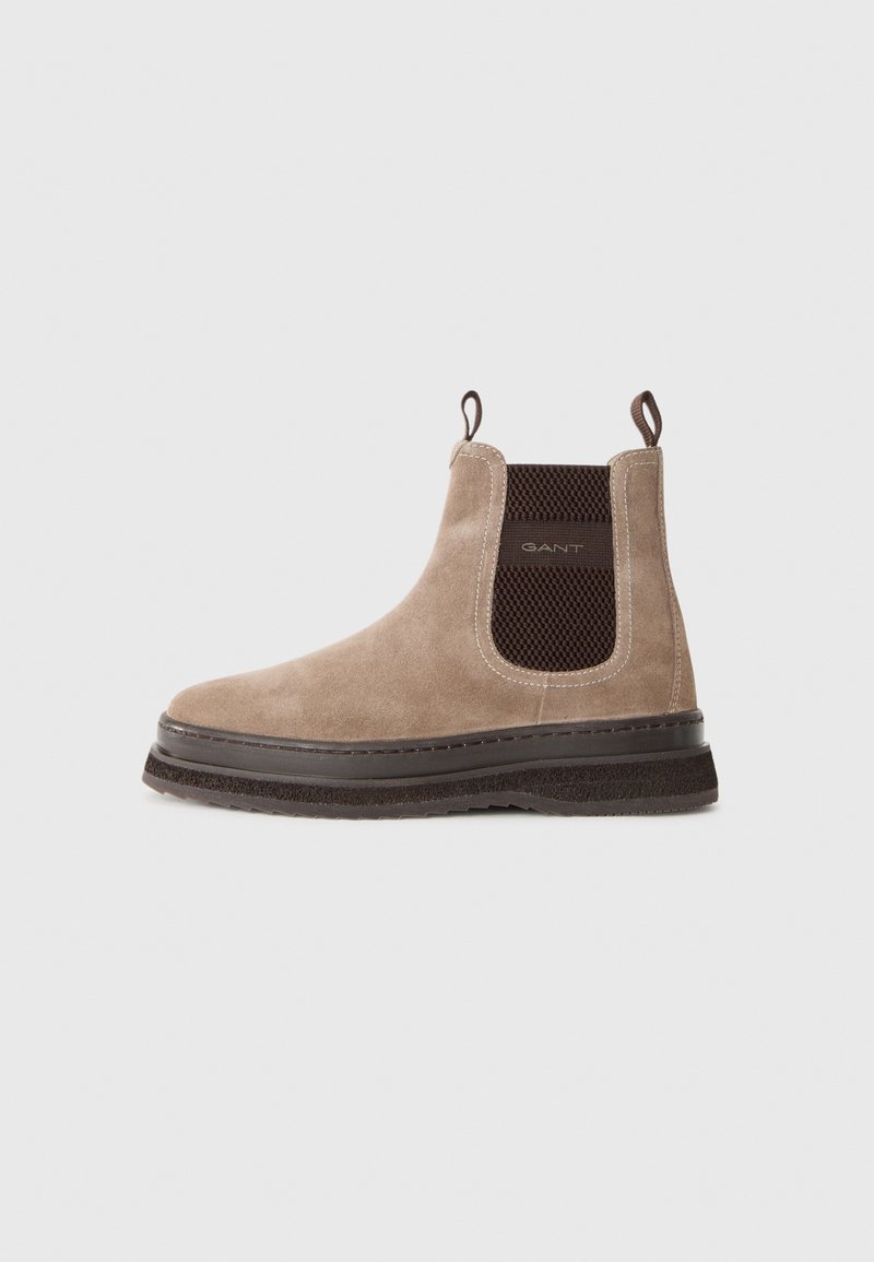 Beige suede ankle Chelsea boot with dark brown elastic side panel and pull tabs, branded "GANT," and thick rubber sole.