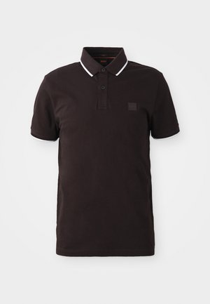 Black polo shirt with short sleeves, a two-button placket, contrasting white collar trim, and a square logo patch on the chest.