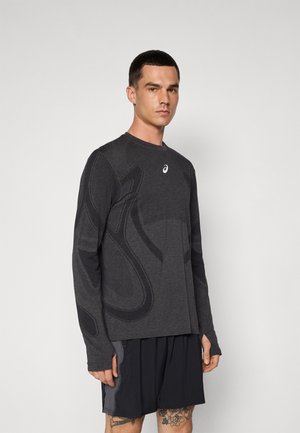 Long-sleeve athletic shirt in dark gray fabric with a textured pattern and logo. Features fitted sleeves and a crew neck design.