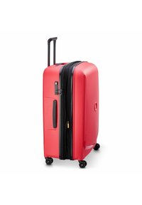 Red hard-shell suitcase with a textured surface, black zipper and accents, extendable handle, and four spinner wheels for easy mobility.