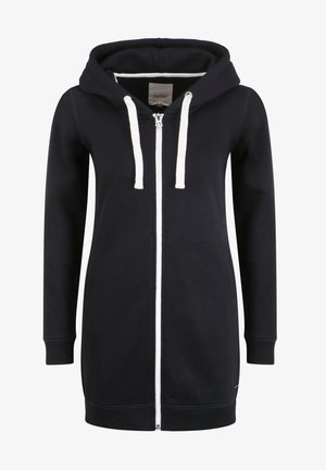 Svart zip-up hettegenser med hvit snorhette og kontrastglidelås. Har lange ermer og en avslappet fit.