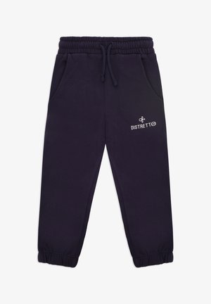 Pantaloni jogger blu navy con vita elastica, coulisse, tasche laterali e polsini a costine. Presentano un logo bianco stampato sulla gamba sinistra.