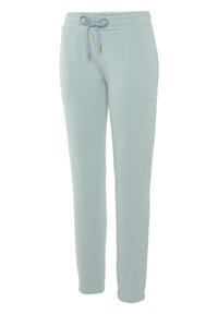 Helle blaue Sweatpants mit einem Kordelzugbund, schmal zulaufenden Beinen und dezent gesticktem Branding in Hüfthöhe. Weicher Baumwollmischstoff.