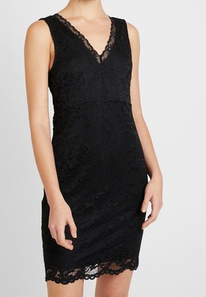 Black lace dress with a V-neckline, sleeveless design, intricate floral pattern, and scalloped hem. Close-fitting silhouette.