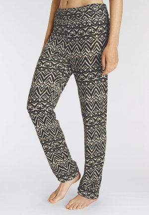Patroon stretchbroek met een zwart en crèmekleurig geometrisch ontwerp, elastische tailleband en lichte stof. Geschikt voor casual of actieve kleding.