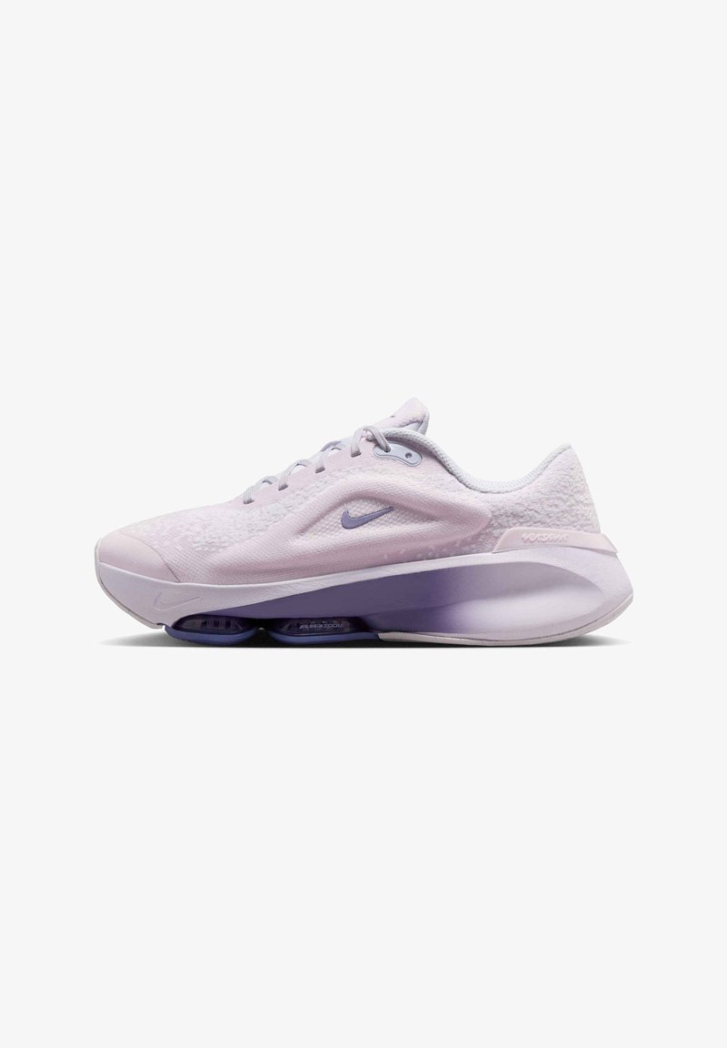 Light purple athletic shoe with textured upper, round toe, and midsole cushioning. Features a purple Nike swoosh and mesh details.