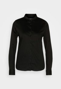 Chemise noire à manches longues boutonnée, avec un col pointu et des poignets, présentée sur un fond gris clair uni.
